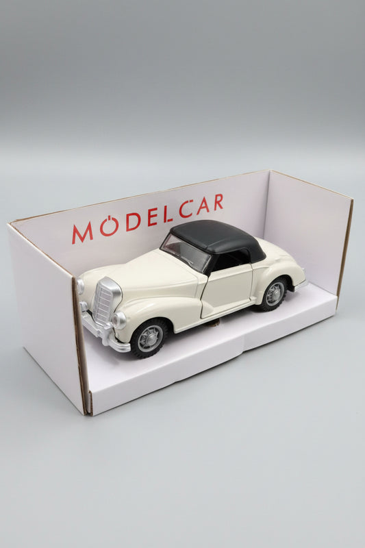 A cream-colored vintage model car with a black convertible top, displayed inside its white packaging box with the brand name 'MODEL CAR' printed in red.